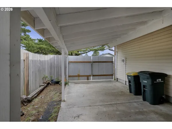 a backyard of a house with table and chairs