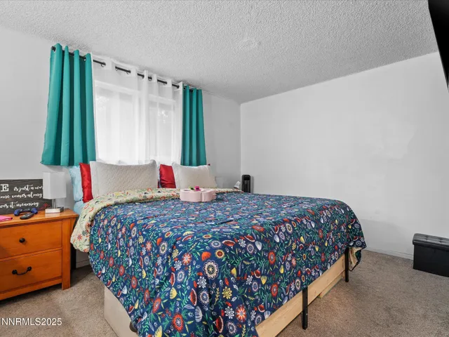 a bedroom with bed and a window