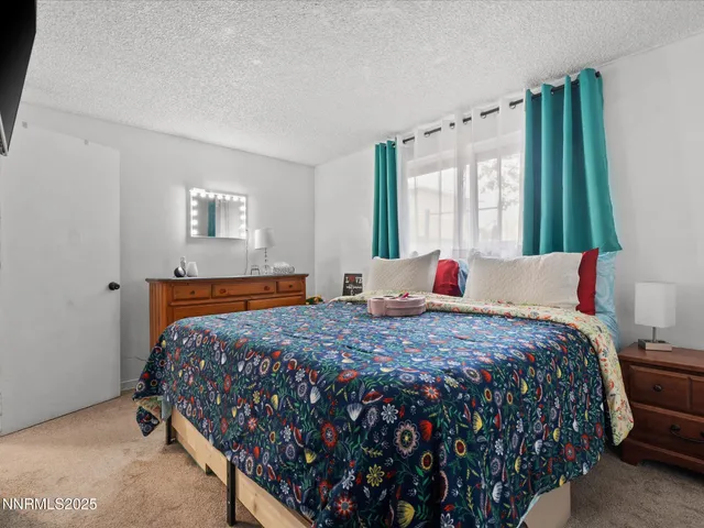 a bedroom with bed and a window