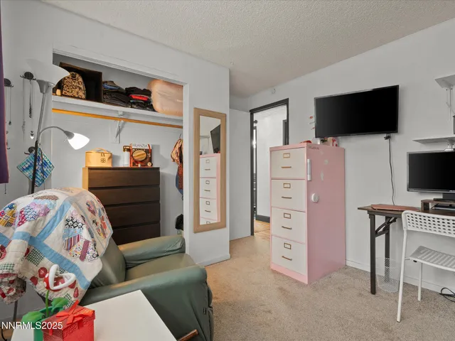 a bedroom with a bed and flat screen tv