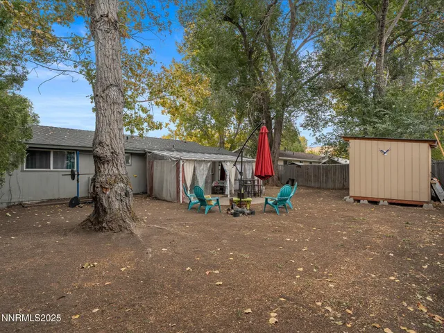 a view of a outdoor space with a tree and sitting area