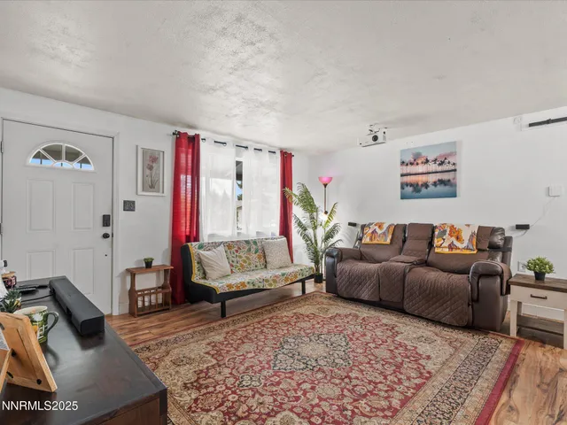 a living room with furniture and a rug