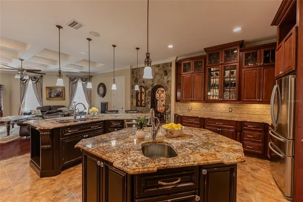 a kitchen with kitchen island granite countertop a sink and a stove