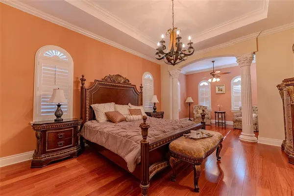 a bedroom with a bed and a chandelier