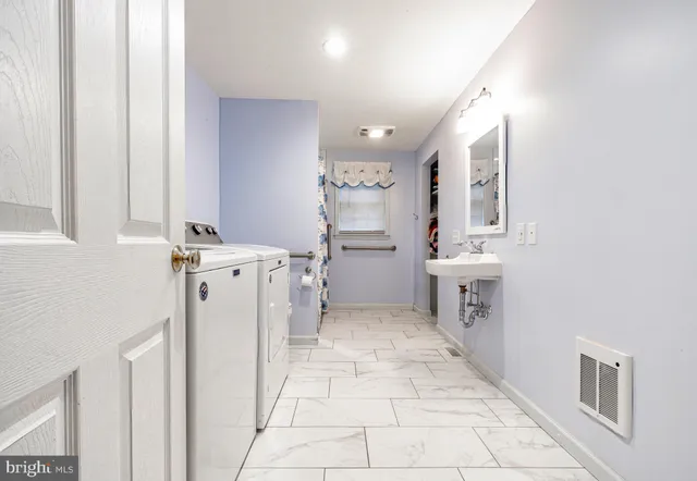 a bathroom with a toilet a sink and mirror