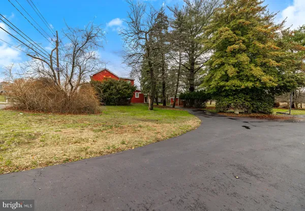 a view of a swimming pool with outdoor seating and a yard