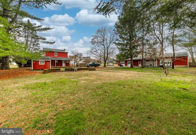 a view of a street with a building and trees in the background