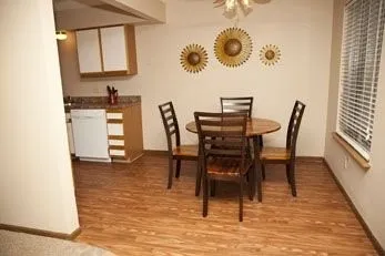 a dining room with furniture and wooden floor