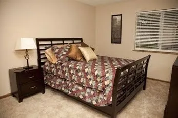 a bed sitting in a bedroom next to a window