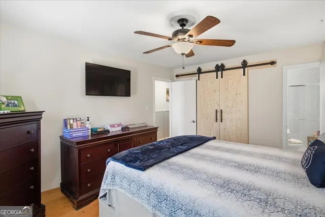 a bedroom with a bed and a flat screen tv