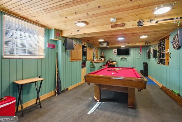 a room with furniture and pool table