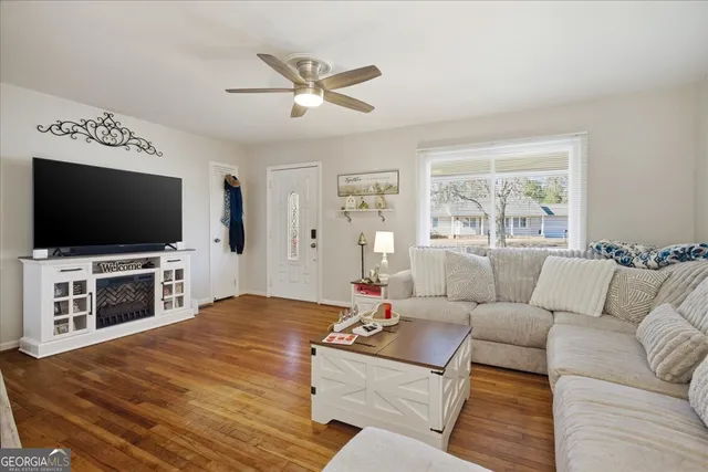 a living room with furniture and a flat screen tv