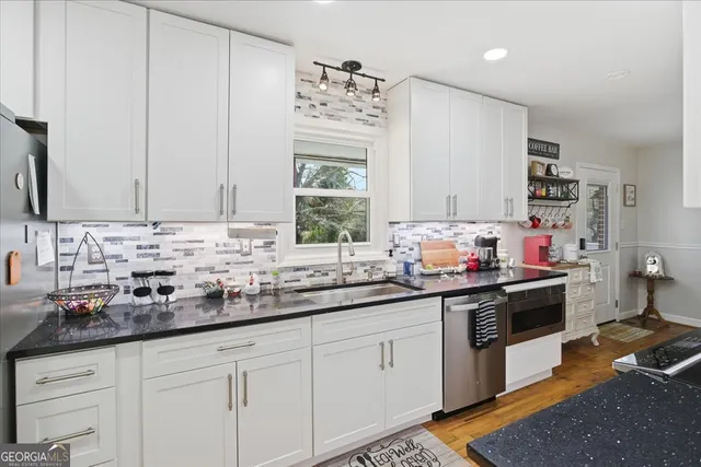a kitchen with a sink stove and cabinets