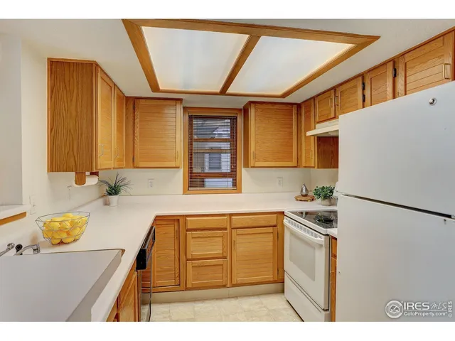 a kitchen with a refrigerator and a sink