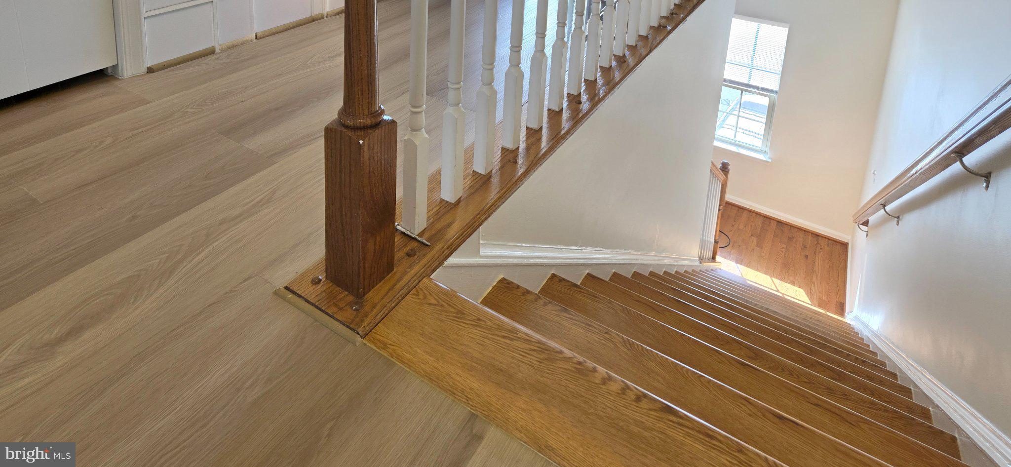 7339 Old Calvary Road Hanover, MD 21076 - Photo 14 of 22 Elegant staircase with warm wood tones.
