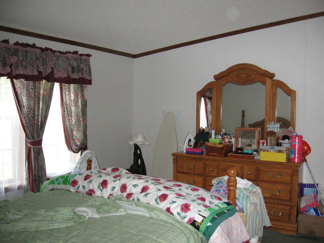 107 Crest Court Blue Ridge, VA 24064 - Photo 6 of 7 a bedroom with a bed a dresser and potted plants on the table