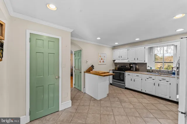 a view of a dining room with furniture and a chandelier