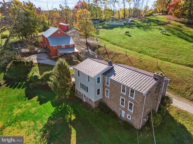 a view of a house with a yard and lake view