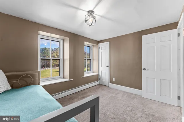 a living room with a bed and a window