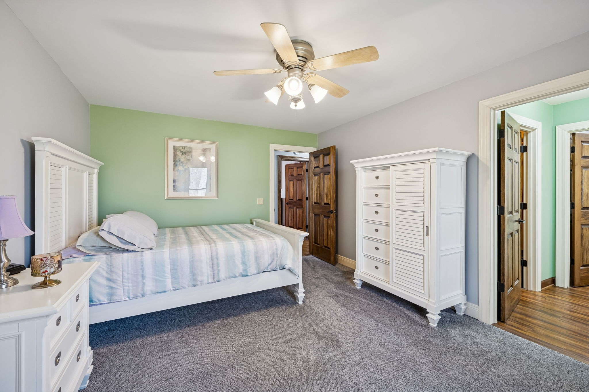 480 Defeated Creek Road Centerville, TN 37033 - Photo 38 of 97 a spacious bedroom with a bed and a chandelier