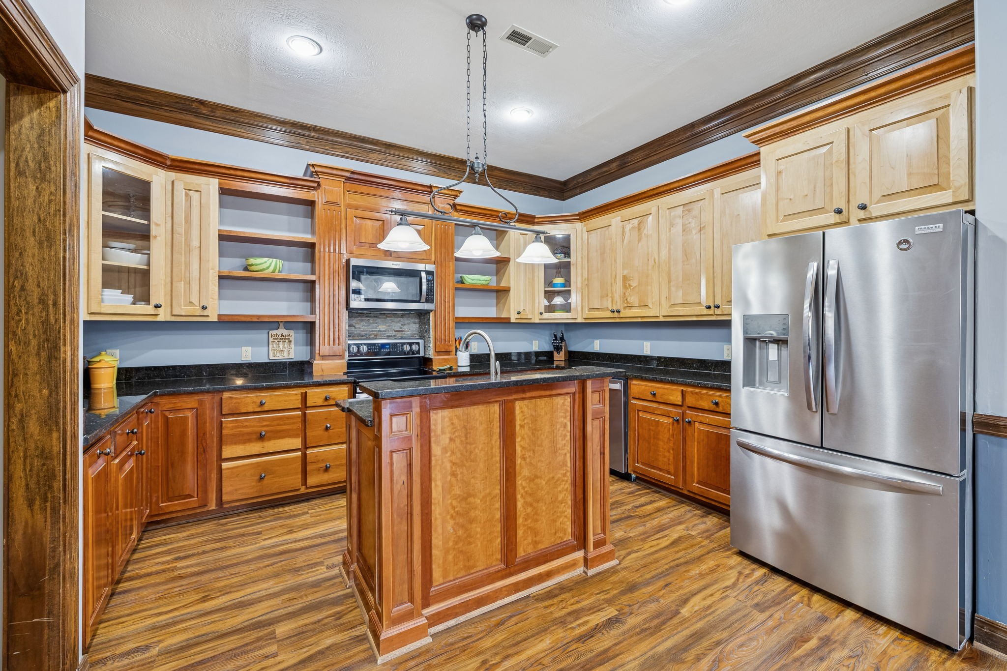 480 Defeated Creek Road Centerville, TN 37033 - Photo 87 of 97 a kitchen with stainless steel appliances granite countertop a refrigerator a stove and a sink with wooden floor