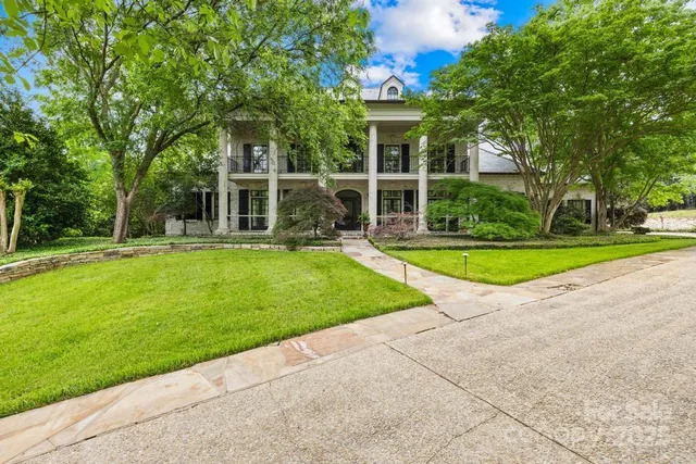 a view of a house with a swimming pool and a yard