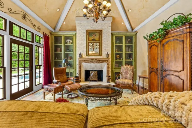 a living room with furniture fireplace and a large window