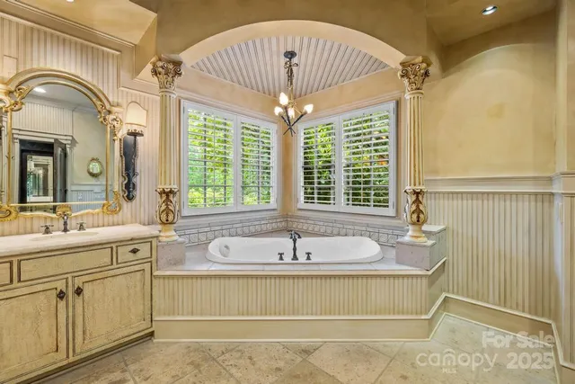 a spacious bathroom with a sink and a mirror