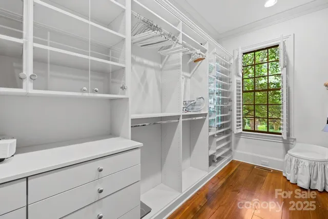 a view of walk in closet and window