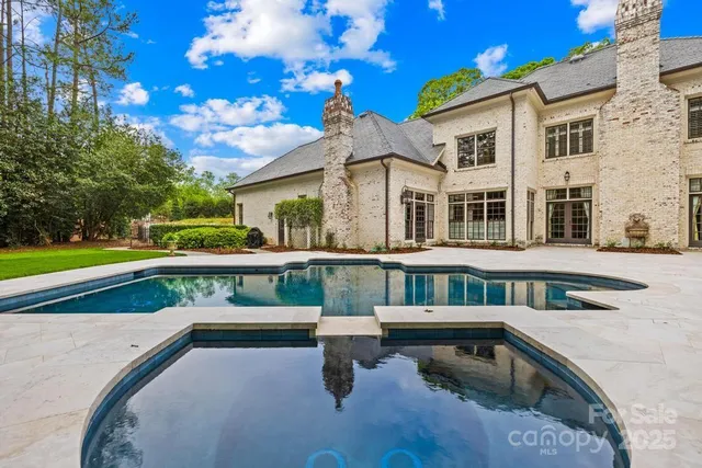 a view of a house with a big yard and potted plants