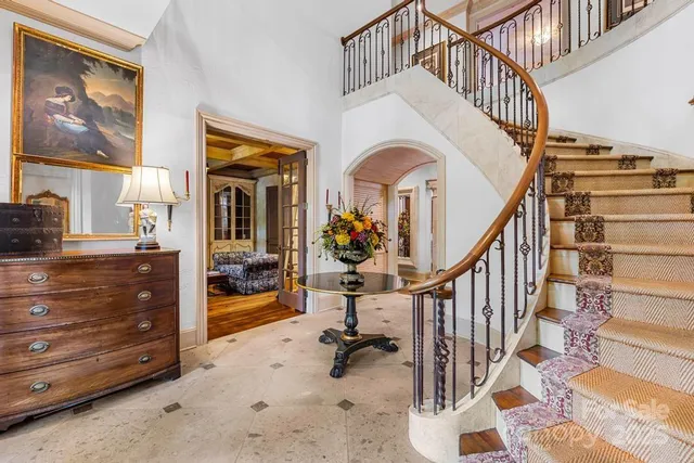 a view of staircase with furniture and a painting on the wall