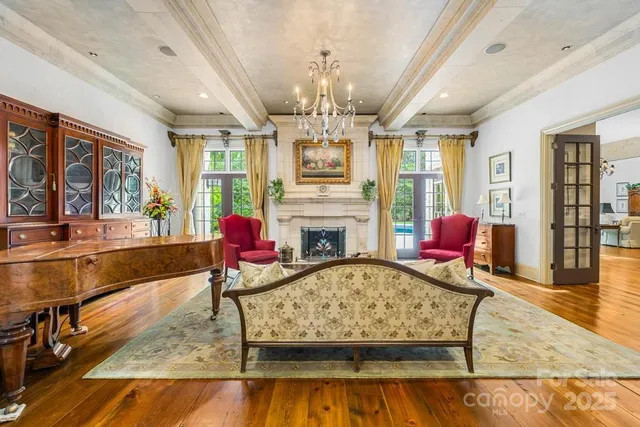 a living room with fireplace furniture or chandelier and a wooden floor