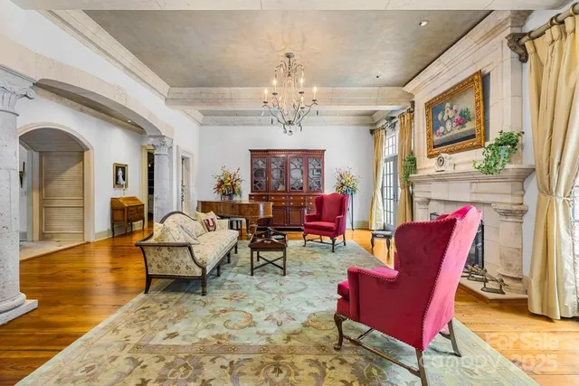 a living room with furniture a dining table and paintings on the wall