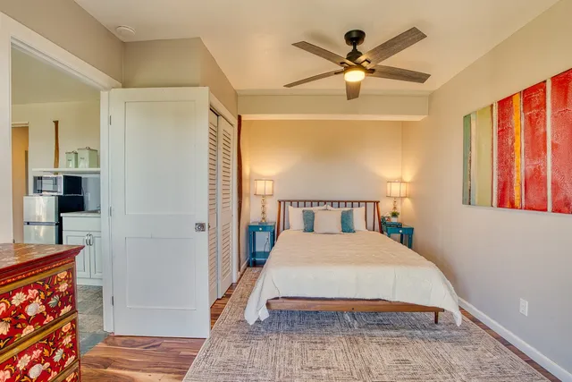 a view of a hallway with wooden floor and entryway