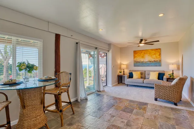 a view of a wooden deck and a backyard