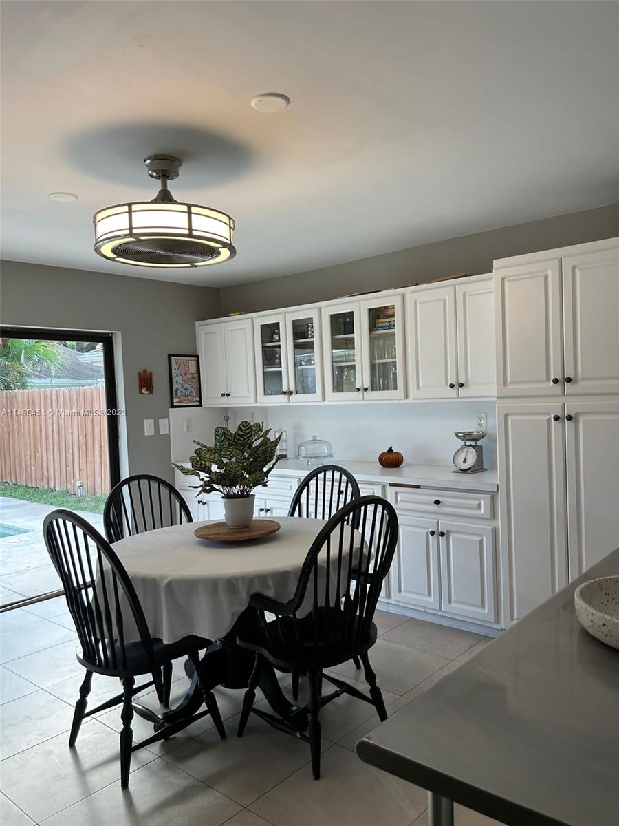 92 Juniper Road, Unit 92 Hollywood, FL 33021 - Photo 20 of 32 a view of a dining room with furniture and chandelier