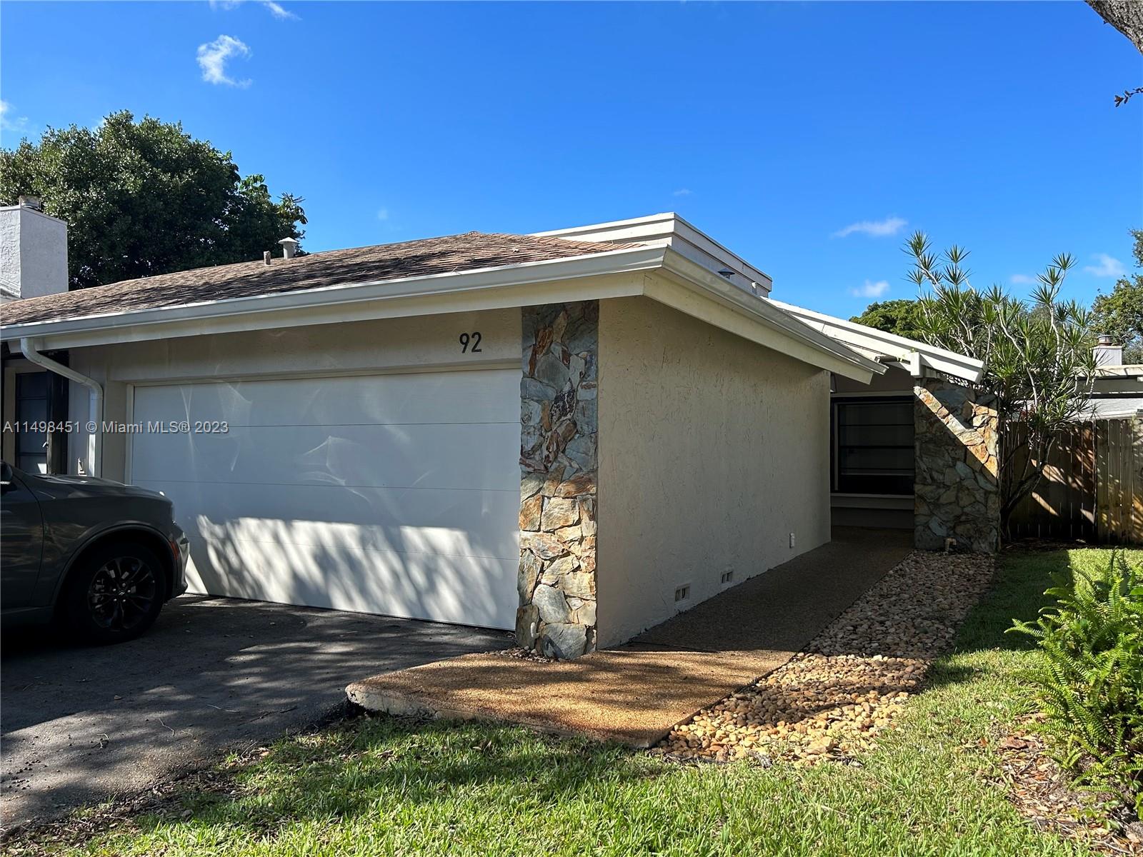92 Juniper Road, Unit 92 Hollywood, FL 33021 - Photo 2 of 32 a view of a house with a yard