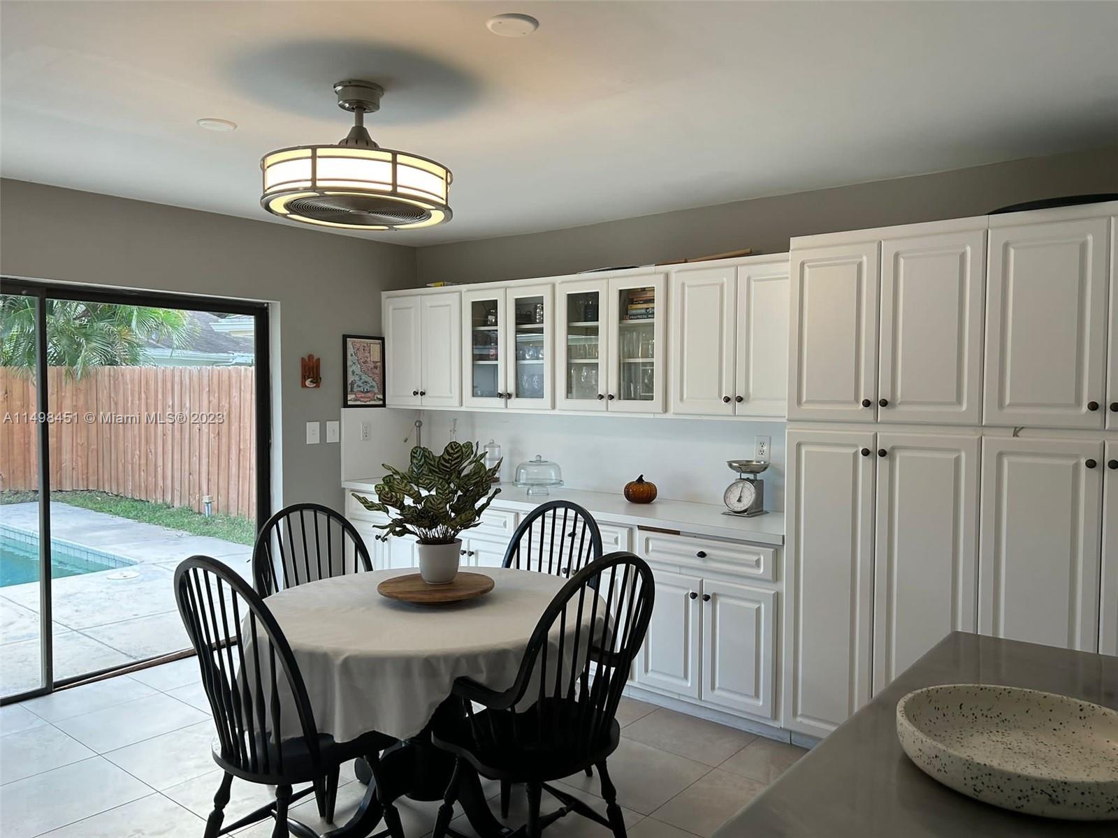 92 Juniper Road, Unit 92 Hollywood, FL 33021 - Photo 21 of 32 a view of a dining room with furniture window and outside view