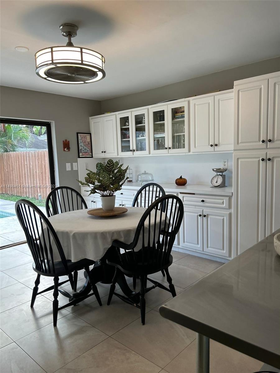 92 Juniper Road, Unit 92 Hollywood, FL 33021 - Photo 26 of 32 a view of a dining room with furniture and chandelier