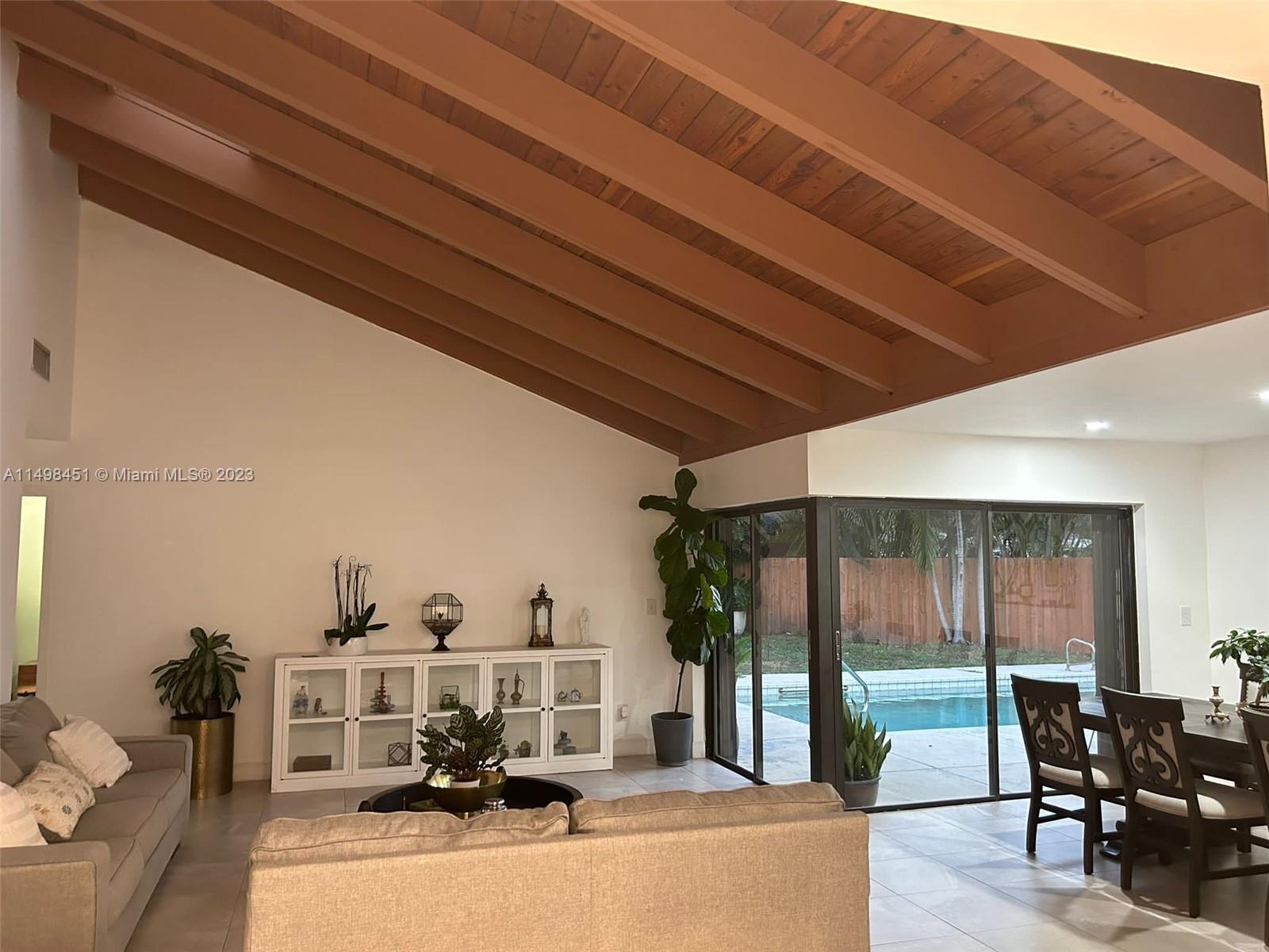 92 Juniper Road, Unit 92 Hollywood, FL 33021 - Photo 29 of 32 a view of a living room and bedroom with furniture