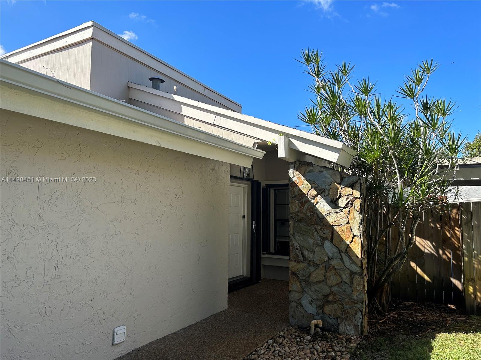 92 Juniper Road, Unit 92 Hollywood, FL 33021 - Photo 32 of 32 a view of entryway with a tree