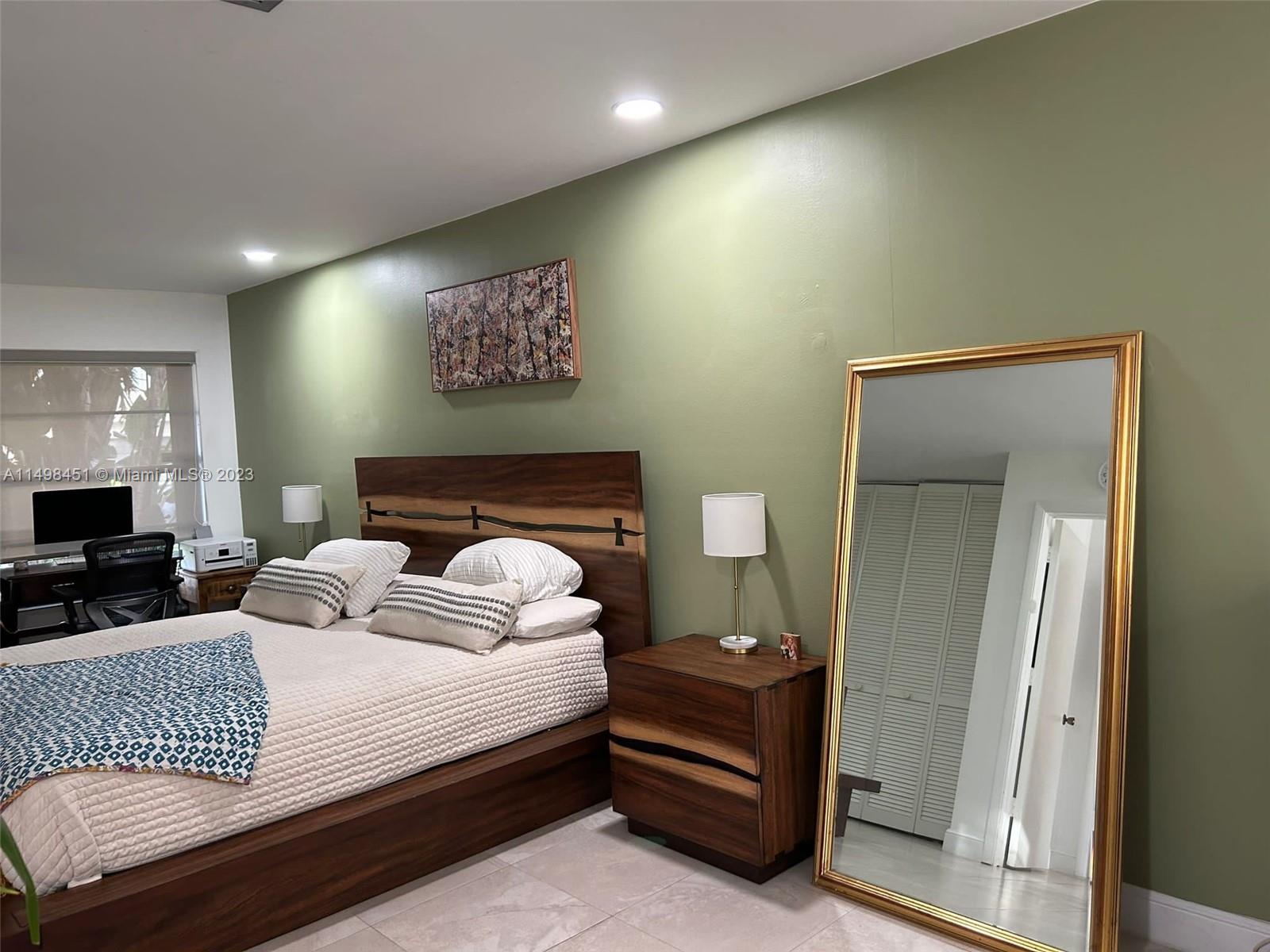 92 Juniper Road, Unit 92 Hollywood, FL 33021 - Photo 8 of 32 a bedroom with a bed and a flat screen tv