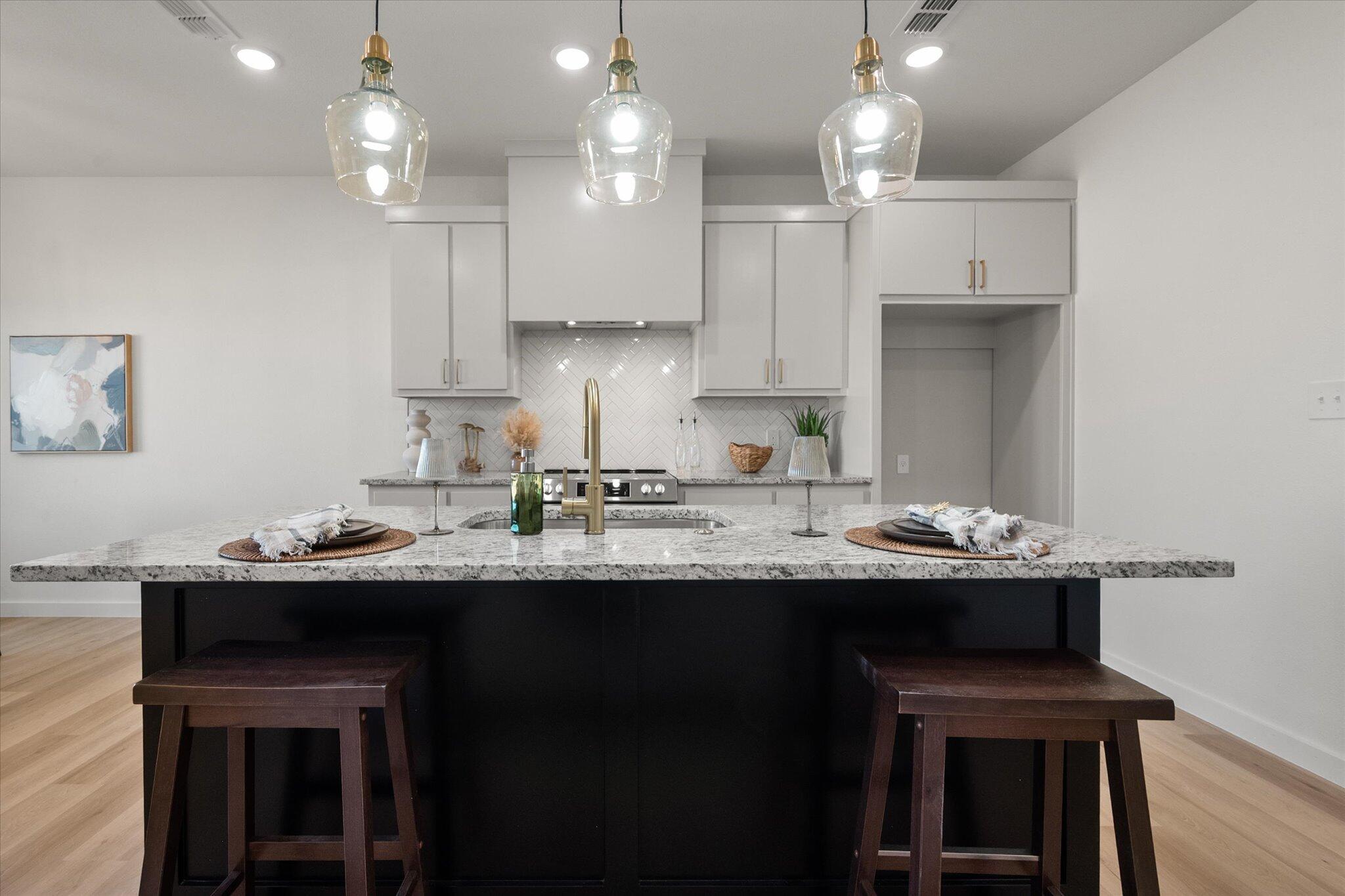 6928 14th Street Lubbock, TX 79416 - Photo 11 of 33 a kitchen with kitchen island stainless steel appliances a sink and a stove
