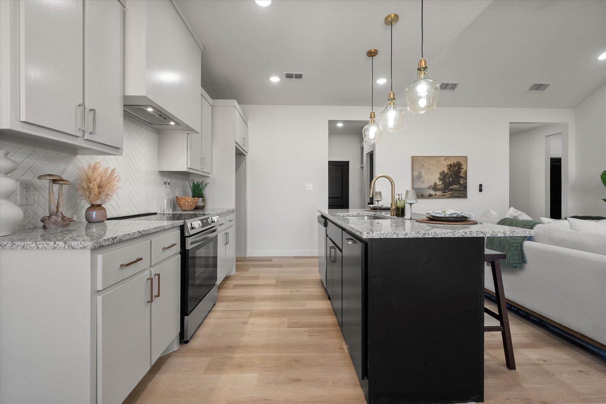 6928 14th Street Lubbock, TX 79416 - Photo 13 of 33 a kitchen with a sink stove and refrigerator