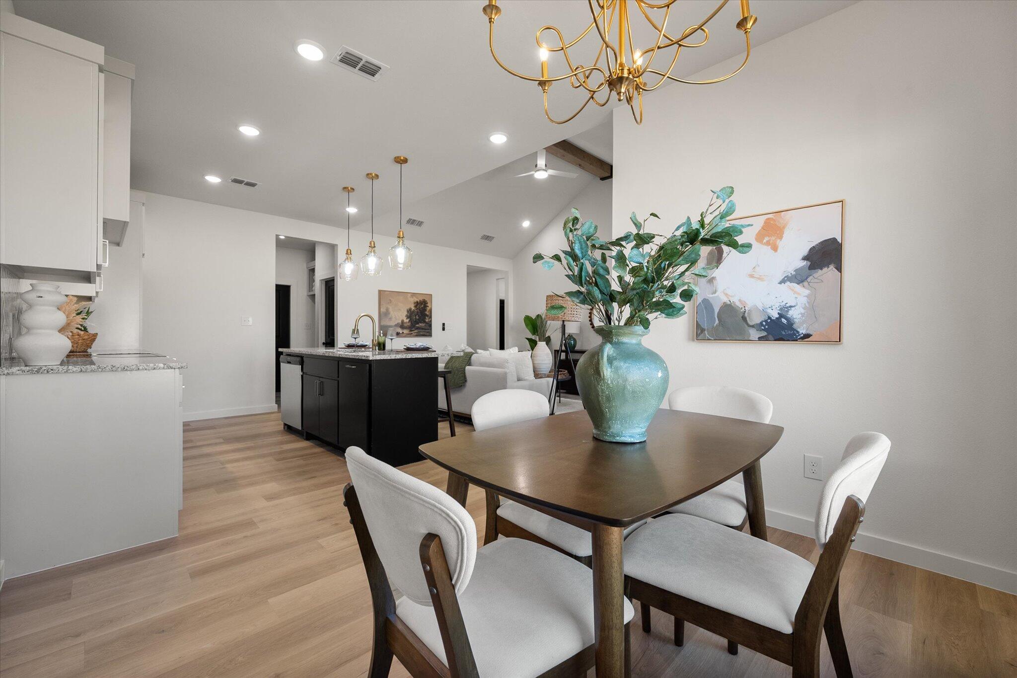 6928 14th Street Lubbock, TX 79416 - Photo 17 of 33 a view of a dining room with furniture and a potted plant