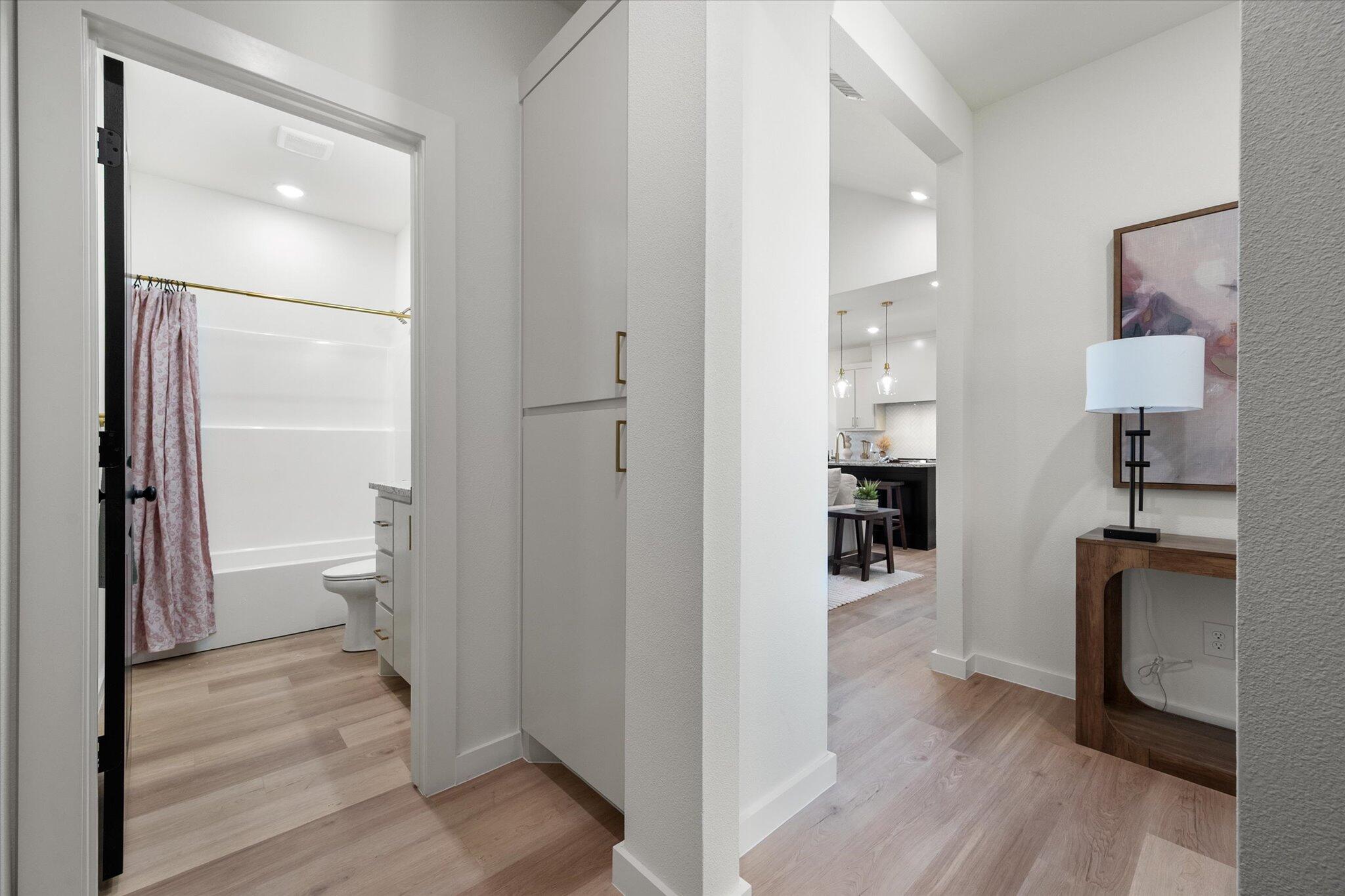 6928 14th Street Lubbock, TX 79416 - Photo 27 of 33 a view of a hallway with wooden floor and a bathroom