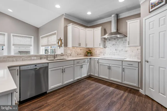 a kitchen with a sink window and cabinets