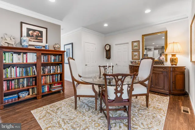 a dining room with furniture and wooden floor