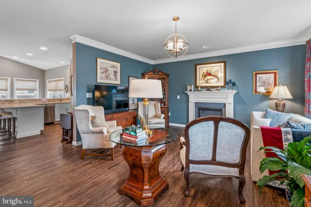 a living room with furniture fireplace and wooden floor