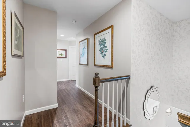 a view of a hallway with paintings on the wall